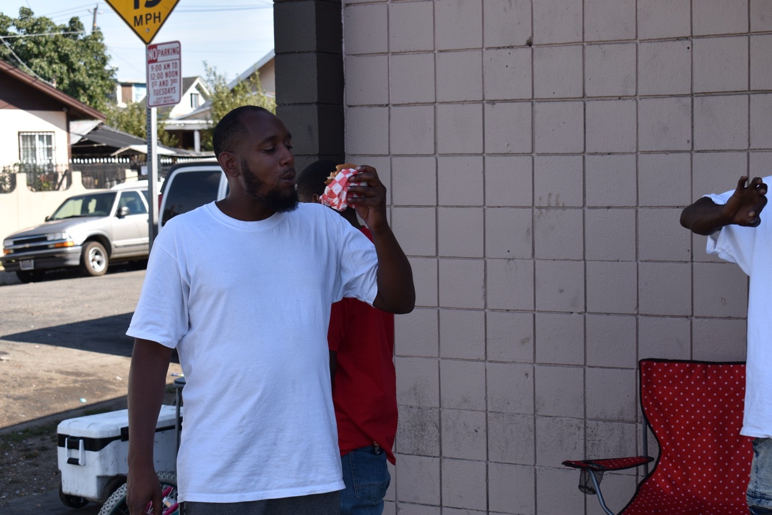 Customer eating a WILDTAYS sandwich.