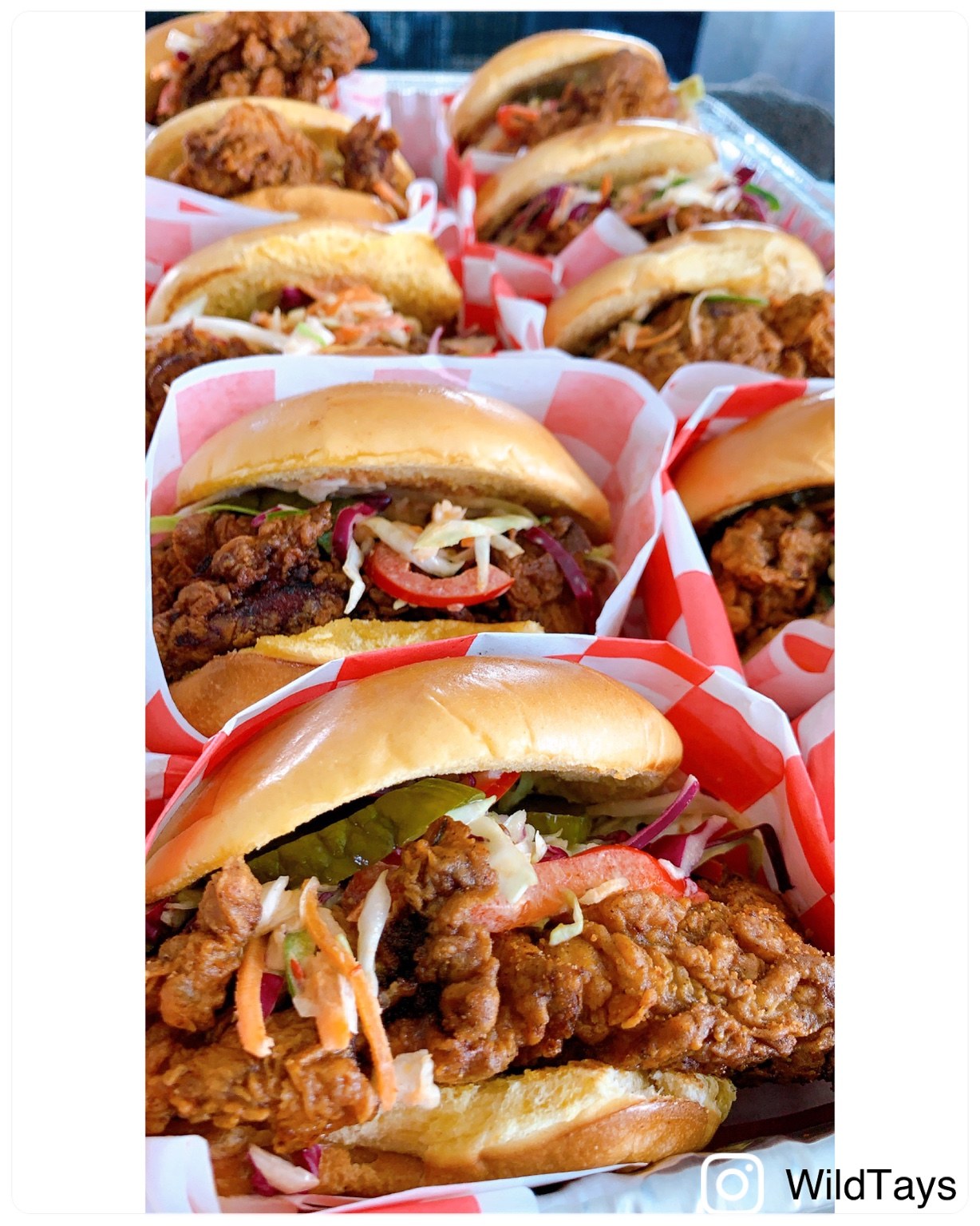 Multiple WILDTAYS chicken sandwiches in branded wraps.