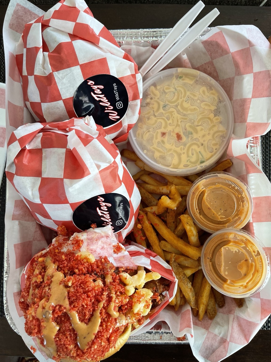 WILDTAYS tray with sandwiches, fries, sauces, and mac.